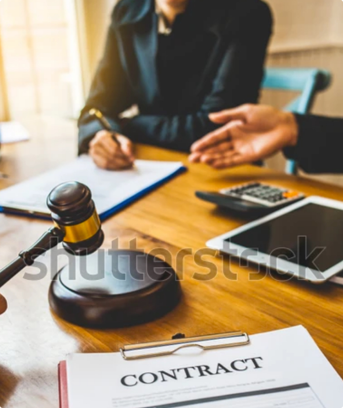 Gavel in front of two people having a negotiation