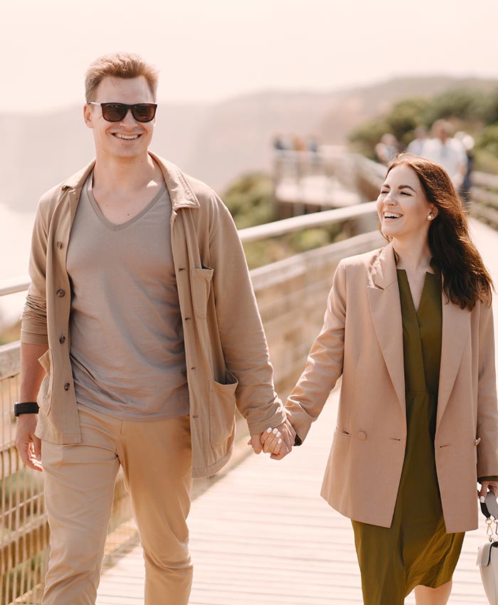 Young couple holding hands while walking
